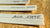 close up of fragrance blotters with hand written names on wooden background