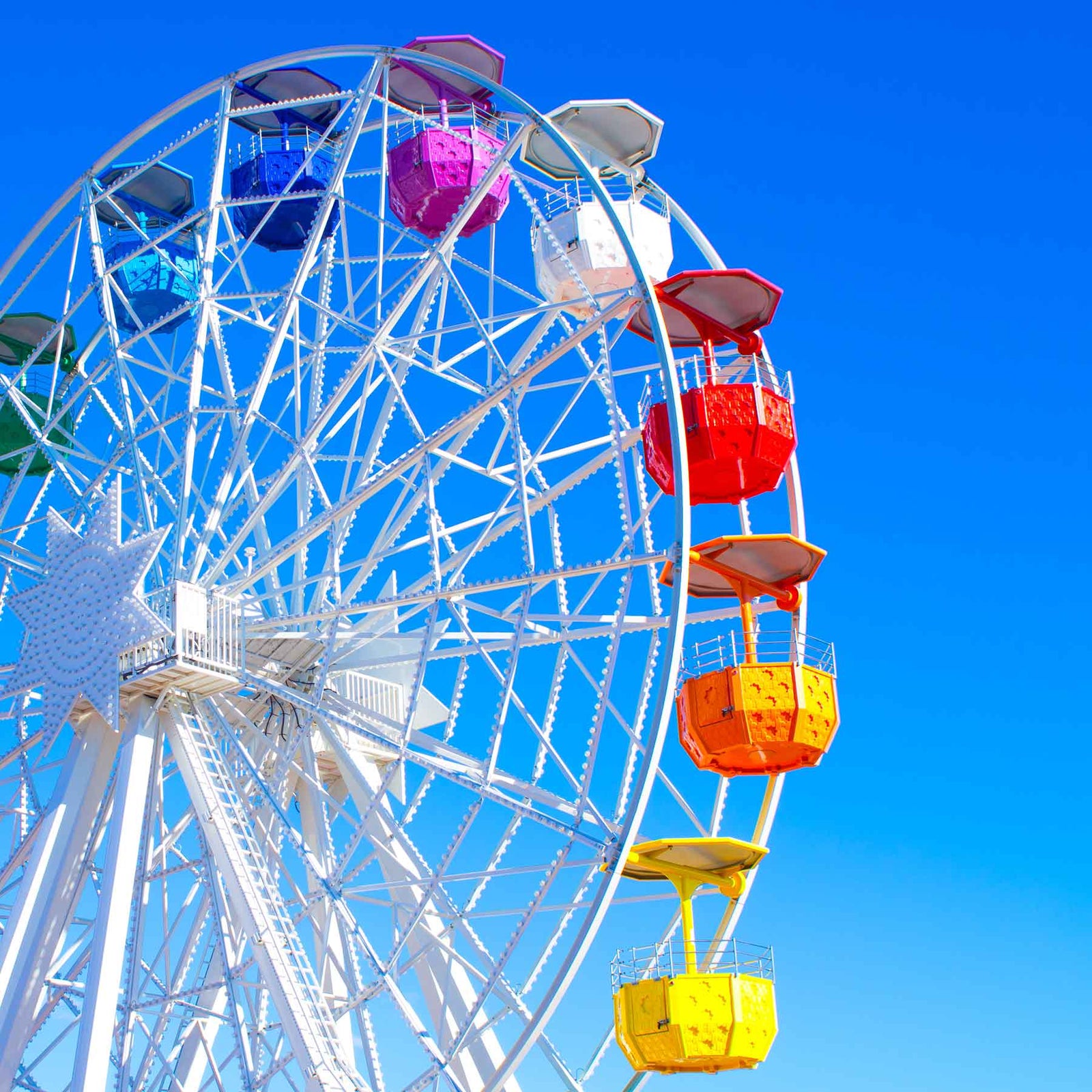 colorful ferris wheel with clear blue sky; https://cdn.shopify.com/videos/c/o/v/f5788316465845759dafc28b1edf20a8.mp4