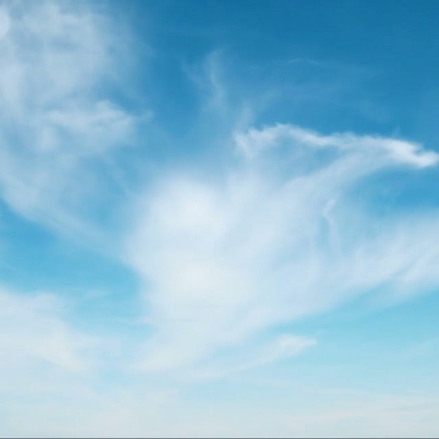 white cirrus clouds in bright blue sky