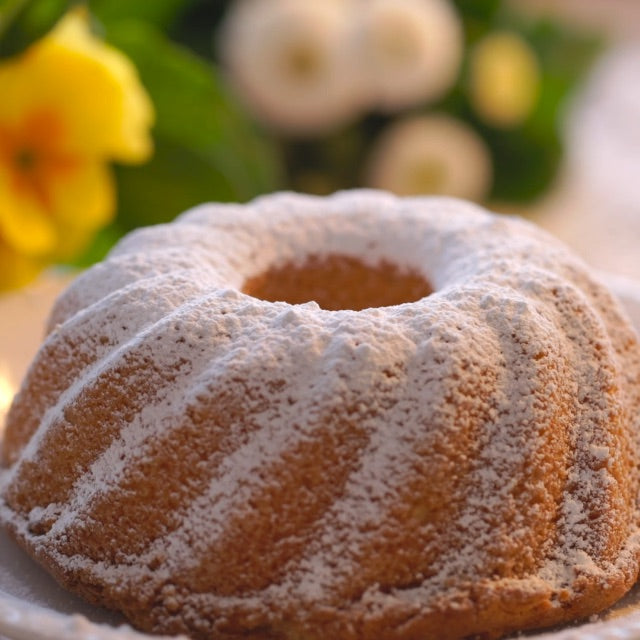 freshly baked madeleine cakes with powdered sugar
