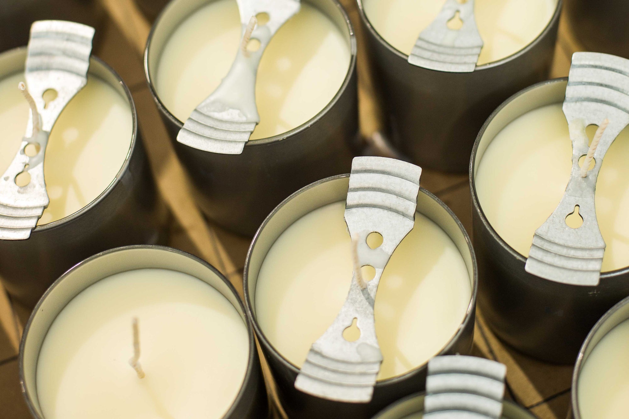 candles in production with wick holders