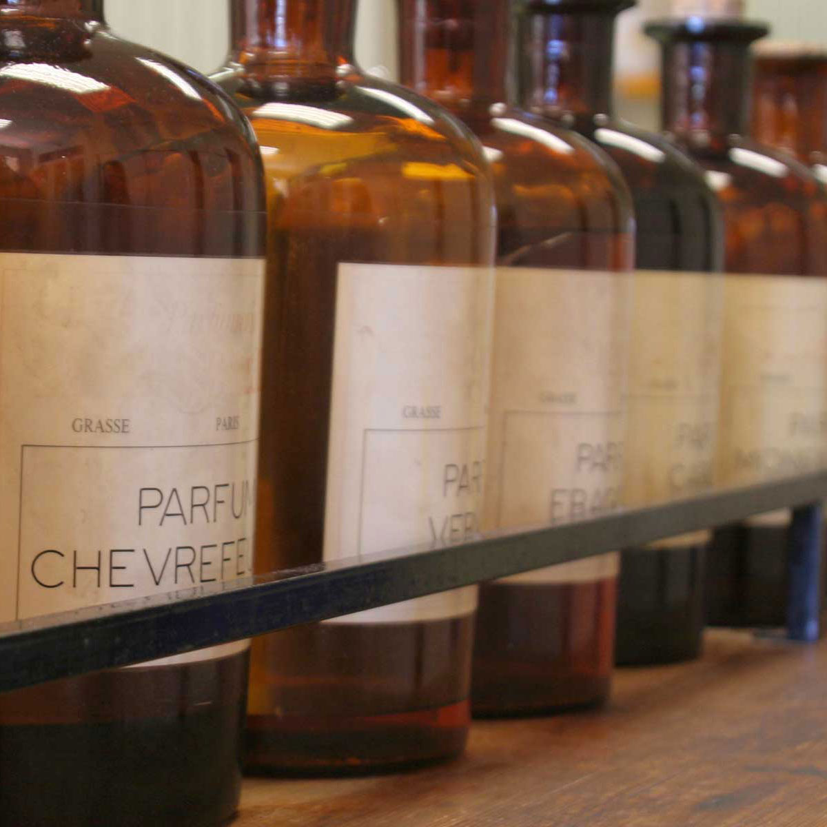 brown fragrance ingredient bottles on a shelf
