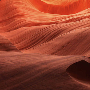 Close-up of red sandstone with wavy patterns; https://cdn.shopify.com/s/files/1/0457/0333/1991/files/Ambre_Nuit_96bd750c-0b3e-4b06-ad16-9fa3f326323a.mp4?v=1648486492