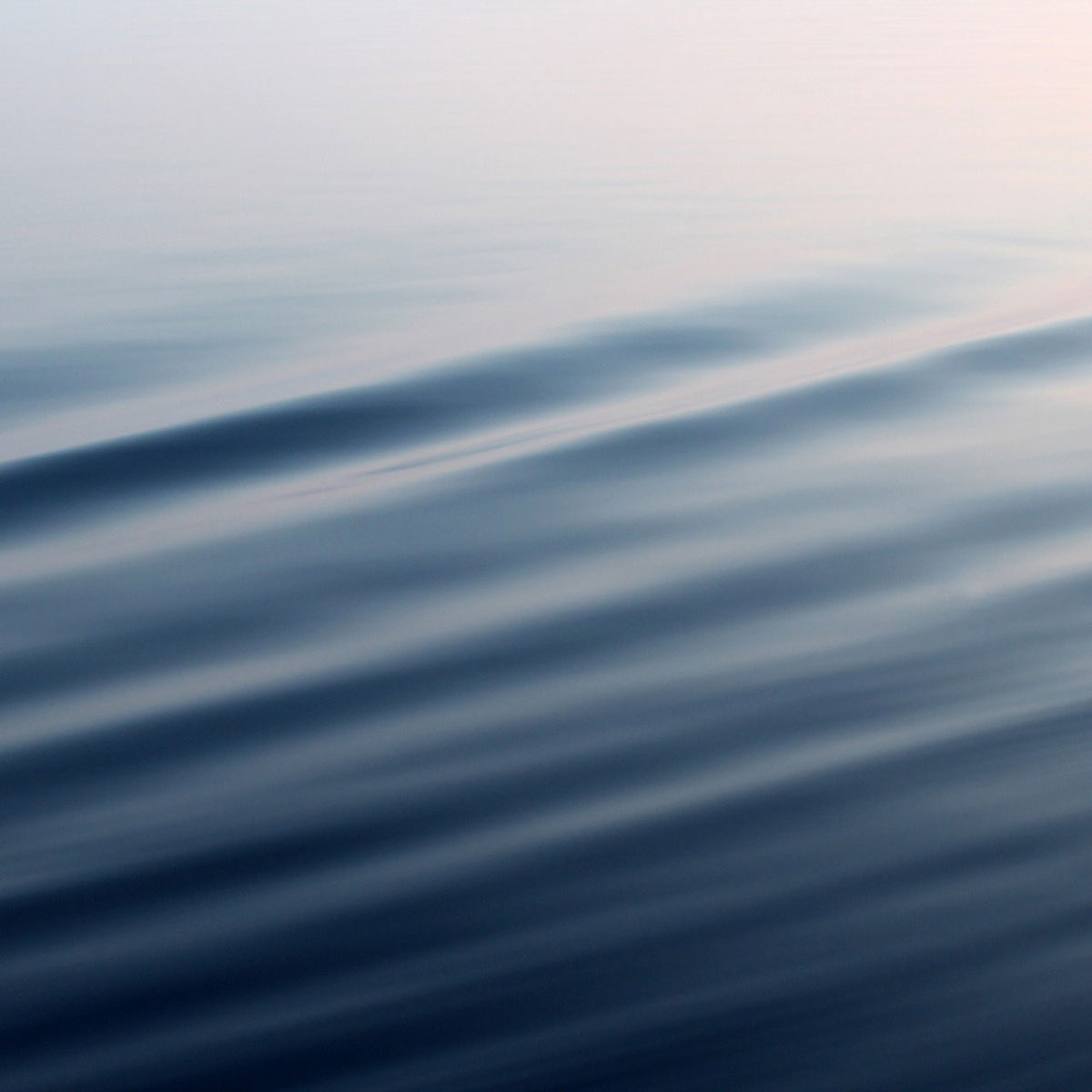 close up of smooth blue water surface with ripples; https://cdn.shopify.com/videos/c/o/v/1e043d0730fe4d73bad0393220f3de5a.mp4