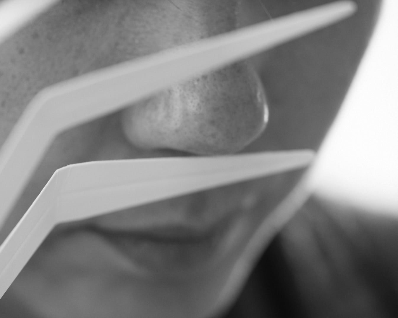 close up of woman smelling fragrance blotter