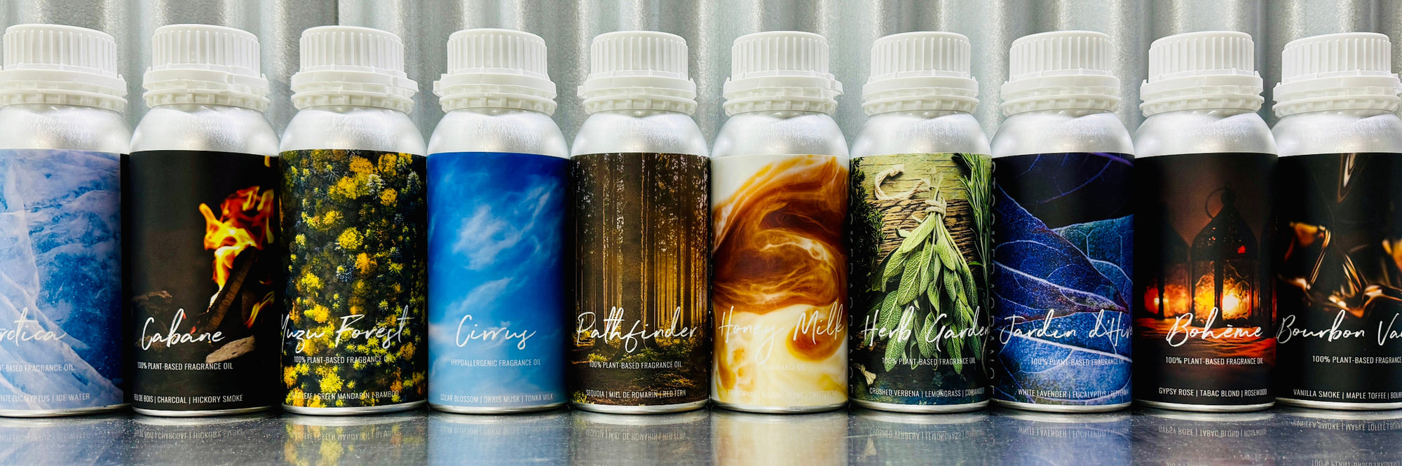 Row of stock fragrance oil bottles with colorful labels on a reflective surface