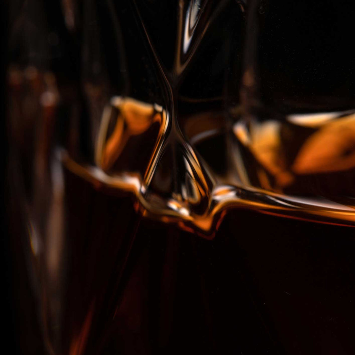 close up of dark liquor and ice in a glass; https://cdn.shopify.com/videos/c/o/v/2ac4baf34a1a458ab5d19e7b649eb0f3.mp4