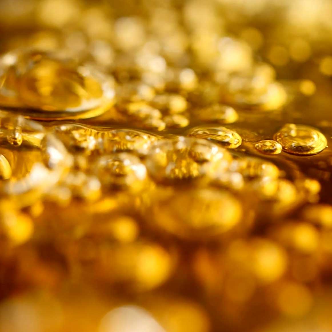 close up of bubbling golden liquid; https://cdn.shopify.com/s/files/1/0457/0333/1991/files/Pineapple_Brulee.mp4?v=1649332984