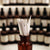 perfume blotters in bottle with perfume bottles in background